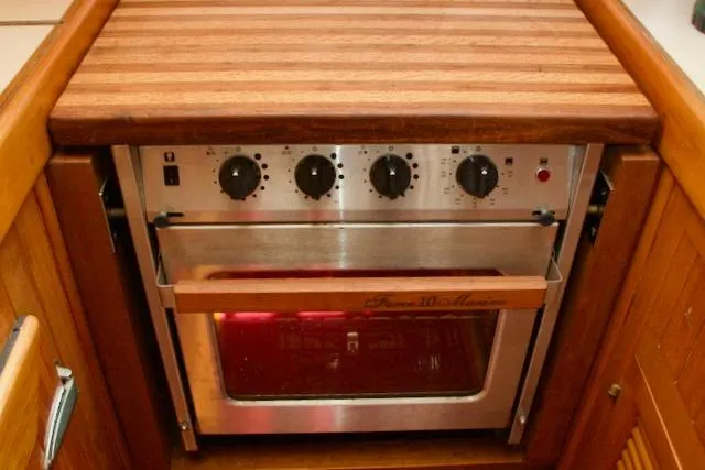 Slide: The Image of Vintage 1986 Passport 42 oven with wooden countertop and control knobs. - 17
