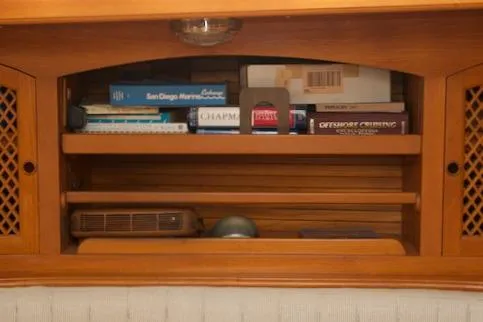 Slide: The Image of Wooden shelf with books and items, inside a 1986 Passport 42 model. - 18