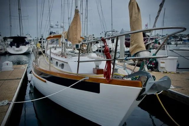 Slide: The Image of Sailboat docked in marina, Passport 42 model, 1986, with wooden deck and covered sails. - 2