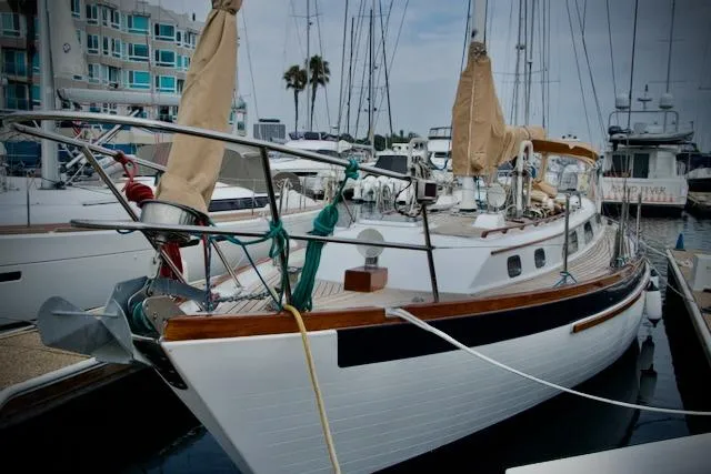 Slide: The Image of Sailboat docked at marina, Passport 42 model, 1986, with covered sails and wooden accents. - 3