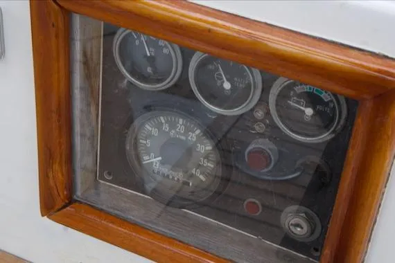 Slide: The Image of 1986 Passport 42 boat dashboard with gauges and wooden frame. - 31