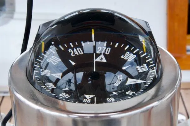 Slide: The Image of Compass on a 1986 Passport 42 sailboat, showing a heading of 270 degrees west. - 32