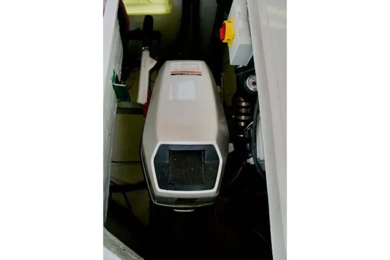 Slide: The Image of 1986 Passport 42 engine compartment with visible machinery and control panel. - 33