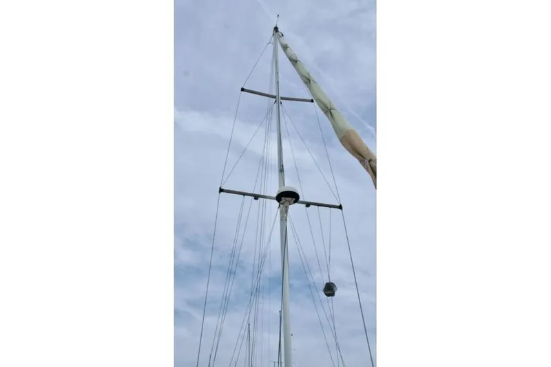 Slide: The Image of Tall sailboat mast against cloudy sky, Passport 42 model, 1986. - 4
