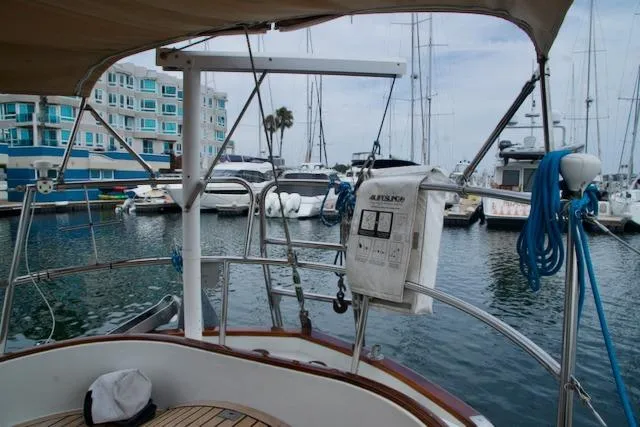 Slide: The Image of Sailboat docked in marina, view from Passport 42, 1986 model, with nearby yachts and buildings. - 9