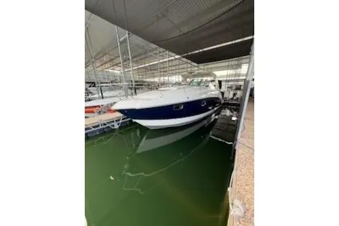 The Image of 2011 Chaparral 330 Signature boat docked in a covered marina. - 0