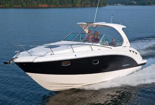 Slide: The Image of Cozy cabin interior of 2011 Chaparral 330 Signature with striped bedding and soft lighting. - 13