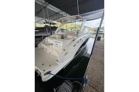 Slide: The Image of 2011 Chaparral 330 Signature boat docked in a marina under a canopy. - 2
