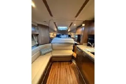 Slide: The Image of 2011 Chaparral 330 Signature boat docked in a marina under a canopy. - 3