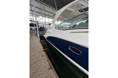 Slide: The Image of 2011 Chaparral 330 Signature boat interior with white seating and helm under a canopy. - 5