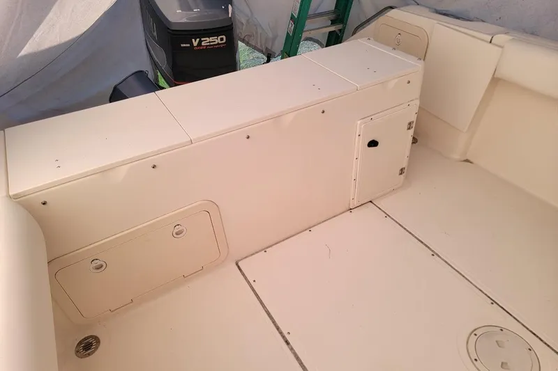 Slide: The Image of 2001 Pursuit 2470 Center Console boat interior with storage compartments. - 10