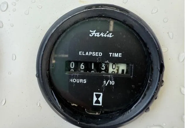 Slide: The Image of 2001 Pursuit 2470 Center Console boat on trailer in driveway. - 13