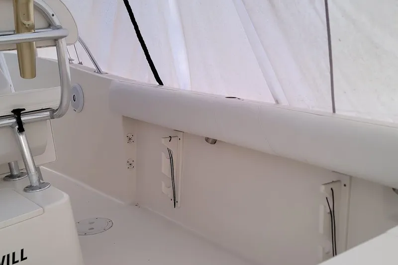 Slide: The Image of Trailer wheels on gravel for 2001 Pursuit 2470 Center Console boat. - 17