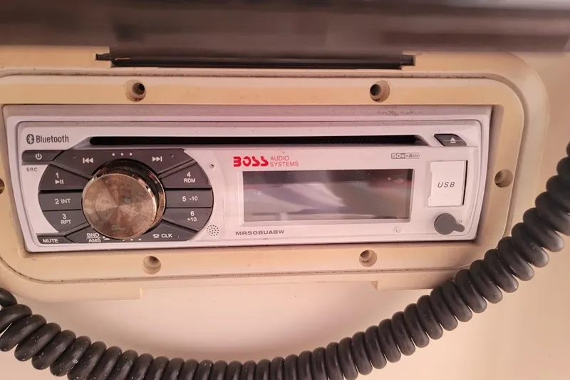 Slide: The Image of 2001 Pursuit 2470 Center Console boat dashboard with steering wheel and Yamaha controls. - 19