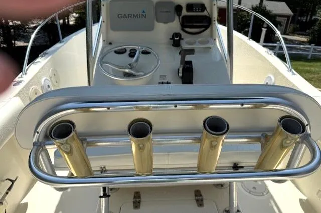 Slide: The Image of 2001 Pursuit 2470 Center Console boat with Garmin navigation, under green canopy. - 2
