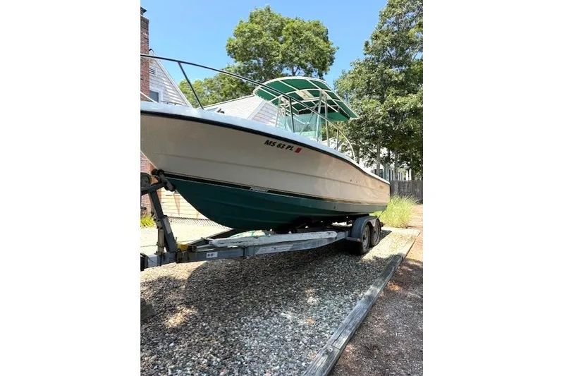 Slide: The Image of 2001 Pursuit 2470 Center Console boat interior with protective cover and steering console. - 22