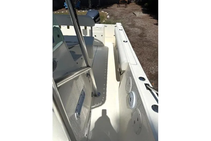 Slide: The Image of 2001 Pursuit 2470 Center Console boat interior with seating and rod holders. - 28
