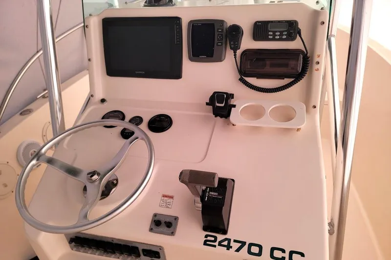 Slide: The Image of 2001 Pursuit 2470 Center Console boat interior with Garmin equipment and rod holders. - 3