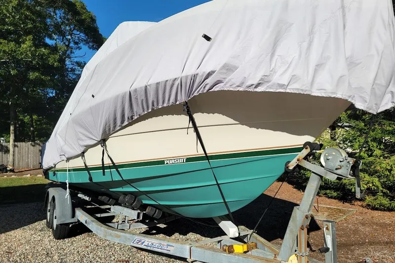 Slide: The Image of 2001 Pursuit 2470 Center Console boat interior with rod holders and console details. - 7