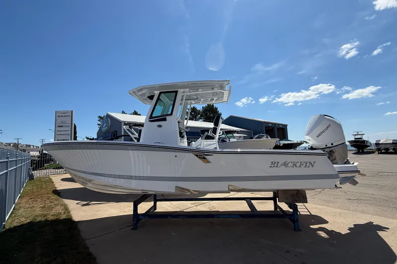 The Image of 2026 Blackfin 242 HB boat displayed outdoors under clear blue sky. - 0