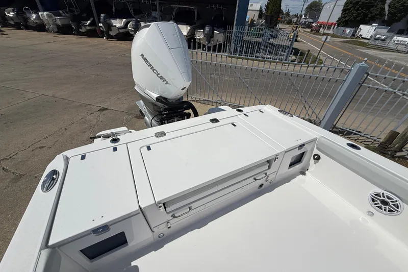 Slide: The Image of 2026 Blackfin 242 HB boat with Mercury outboard engine, docked in a marina. - 12