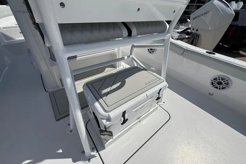 Slide: The Image of 2026 Blackfin 242 HB boat interior with seating and storage area. - 13