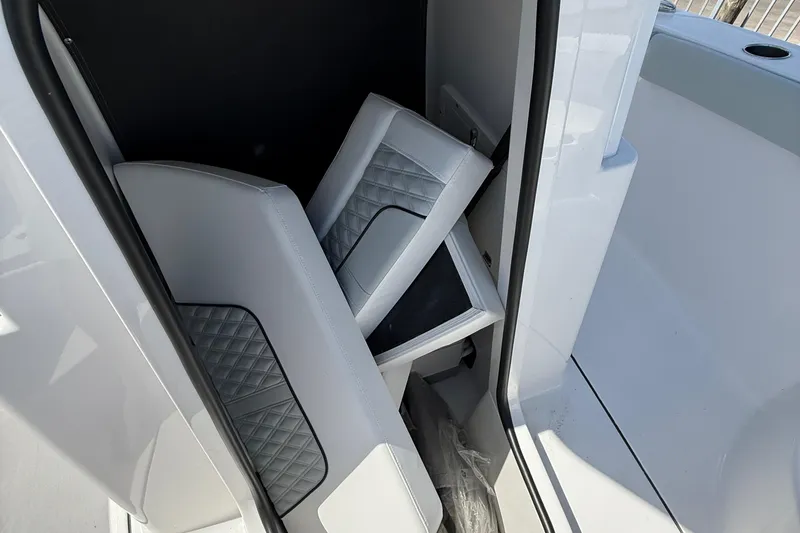 Slide: The Image of 2026 Blackfin 242 HB boat interior with folded seats and sleek design. - 18