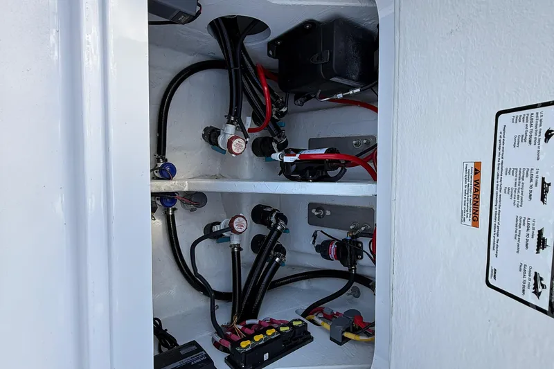 Slide: The Image of 2026 Blackfin 242 HB boat wiring and components in storage compartment. - 21