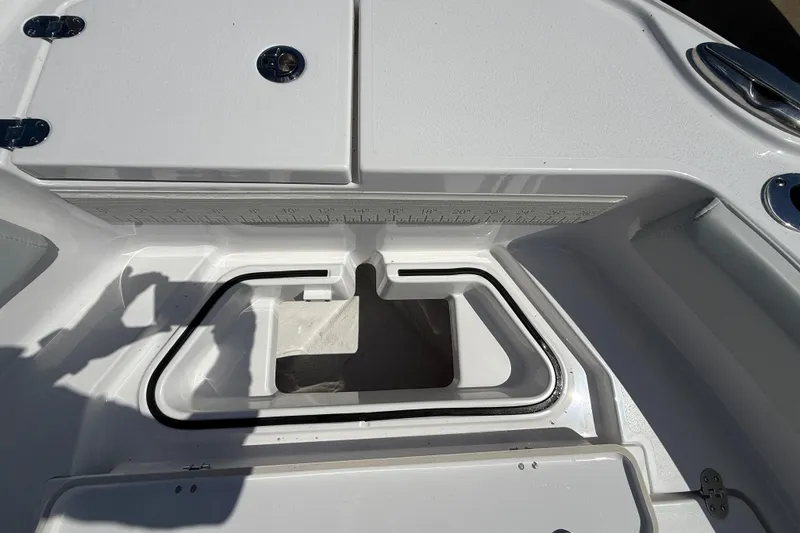 Slide: The Image of 2026 Blackfin 242 HB boat deck with storage compartments and ruler markings. - 25