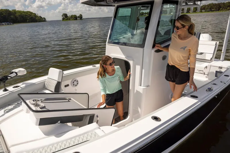Slide: The Image of Manufacturer Provided Image: Two people on a 2026 Blackfin 242 HB boat, enjoying a sunny day on the water. - 26