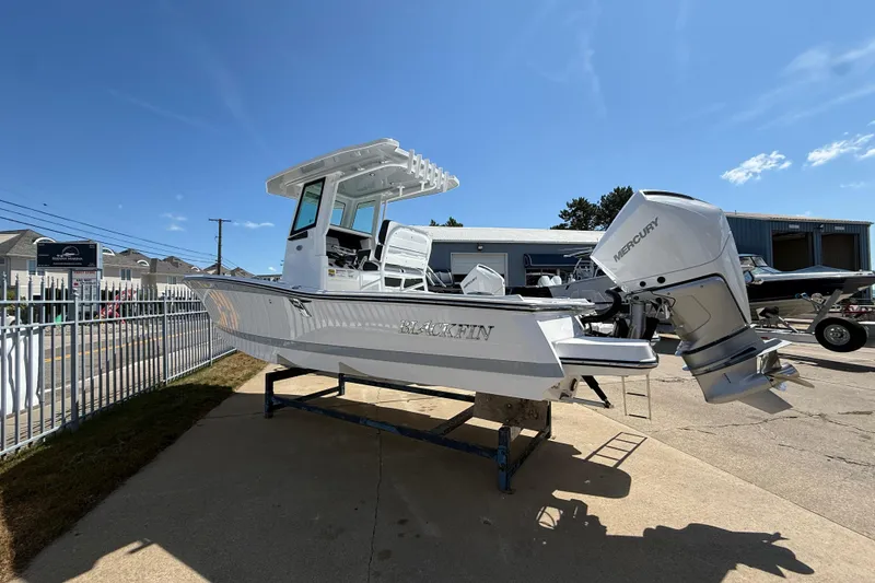 Slide: The Image of 2026 Blackfin 242 HB boat with Mercury engine displayed outdoors. - 3
