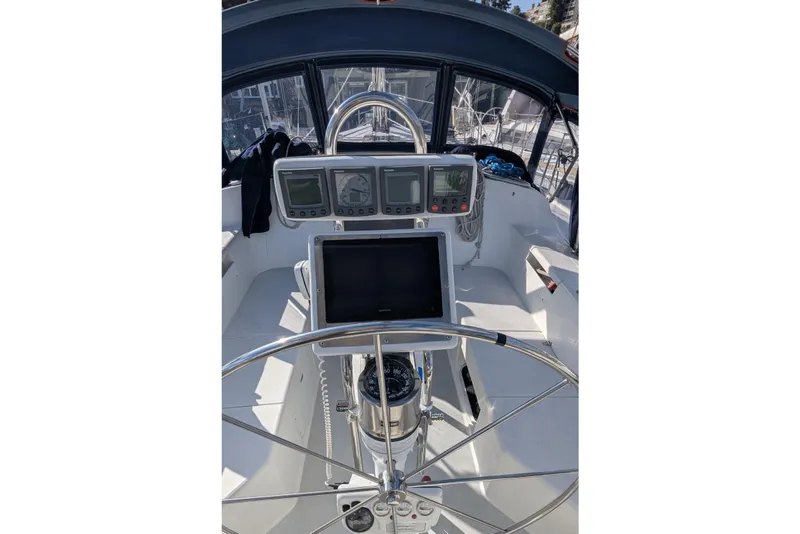 Slide: The Image of Cockpit of 2003 Catalina 42 MkII sailboat with navigation instruments and steering wheel. - 12