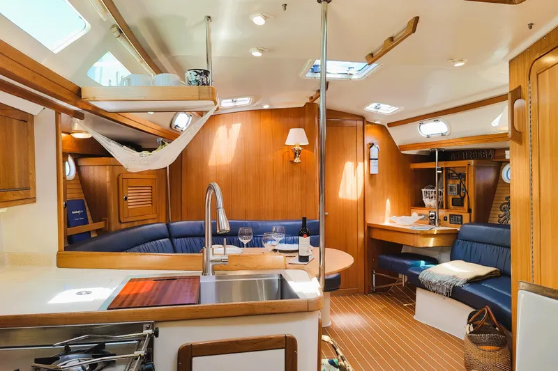 Slide: The Image of Interior of 2003 Catalina 42 MkII sailboat with cozy seating and wooden finishes. - 14