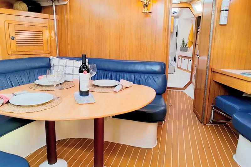 Slide: The Image of Interior of 2003 Catalina 42 MkII yacht with dining area and wooden finish. - 15