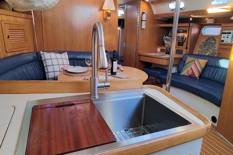 Slide: The Image of Interior of 2003 Catalina 42 MkII sailboat with modern kitchen and cozy seating area. - 19