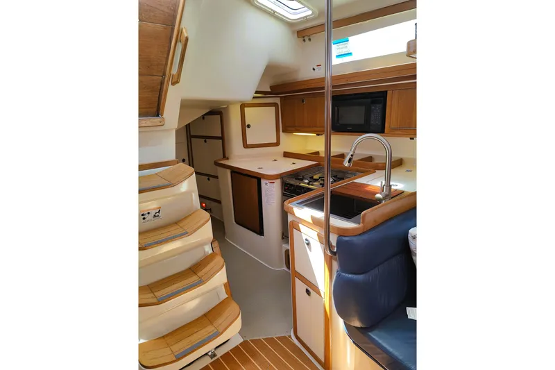 Slide: The Image of Interior of 2003 Catalina 42 MkII sailboat with kitchen and seating area. - 20