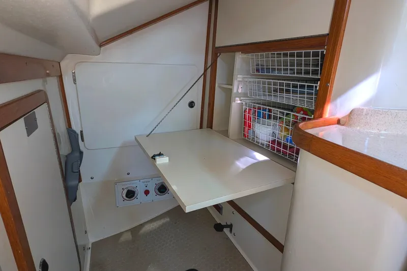 Slide: The Image of 2003 Catalina 42 MkII interior with foldable table and storage shelves. - 21
