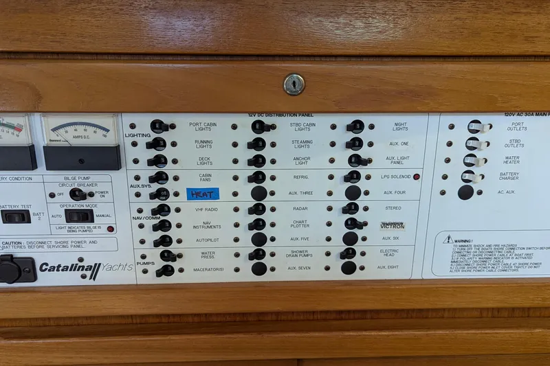 Slide: The Image of Control panel of a 2003 Catalina 42 MkII yacht with various switches and gauges. - 23