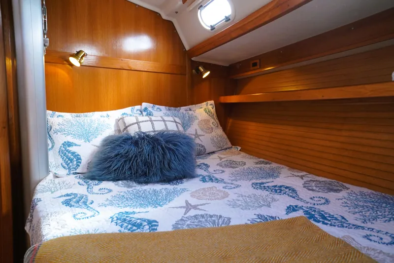 Slide: The Image of Cozy cabin interior of 2003 Catalina 42 MkII sailboat with nautical-themed bedding. - 25