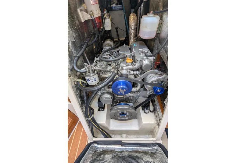 Slide: The Image of Engine compartment of a 2003 Catalina 42 MkII sailboat, showcasing mechanical components. - 29