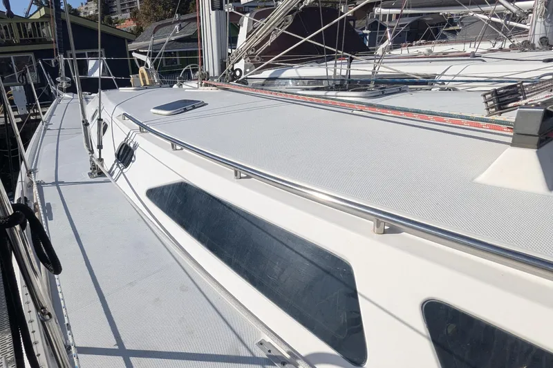 Slide: The Image of 2003 Catalina 42 MkII sailboat deck with stainless steel railings and hatches. - 3