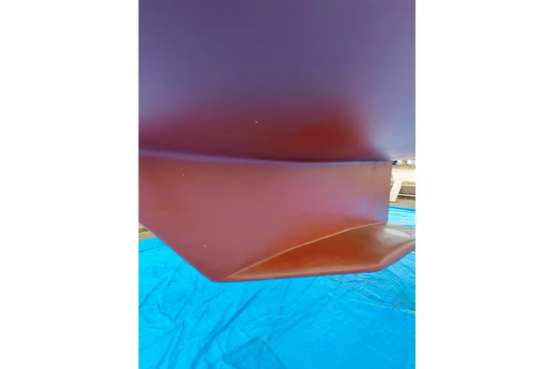 Slide: The Image of Close-up of 2003 Catalina 42 MkII boat hull on blue tarp. - 32