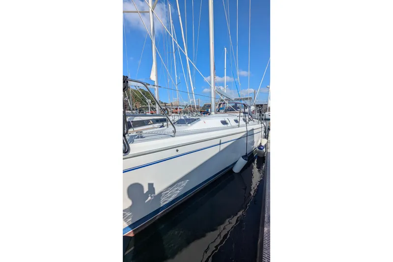 Slide: The Image of 2003 Catalina 42 MkII sailboat docked under clear blue sky. - 4