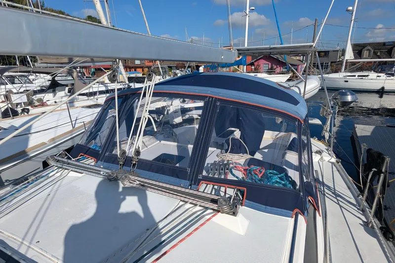 Slide: The Image of 2003 Catalina 42 MkII sailboat docked at marina, featuring blue canvas cover and rigging. - 9