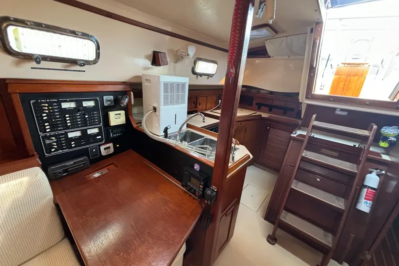 Slide: The Image of Interior of 1995 Island Packet 40 sailboat with navigation station and galley. - 12