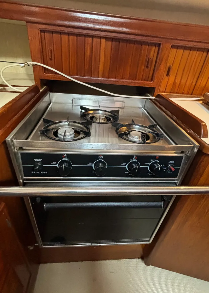 Slide: The Image of Island Packet 40 yacht kitchen with a three-burner stove and oven, 1995 model. - 17
