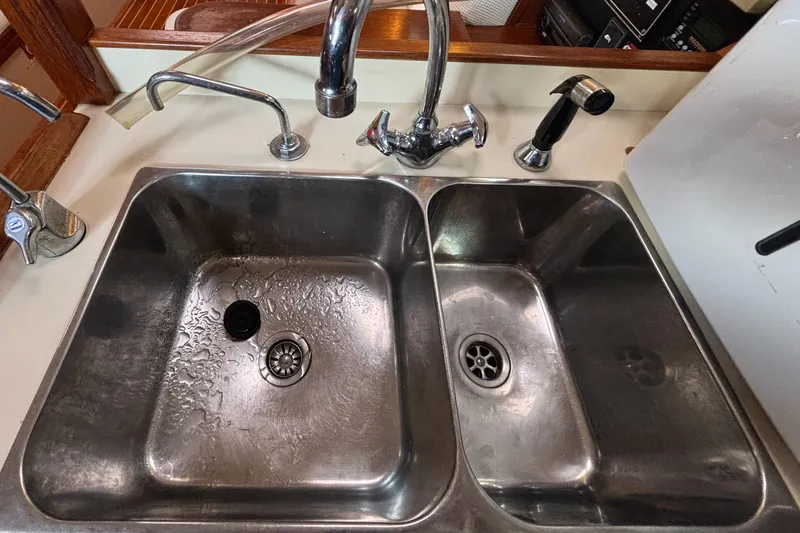 Slide: The Image of Double stainless steel sink in a 1995 Island Packet 40 yacht kitchen. - 18