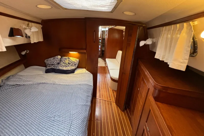 Slide: The Image of Cozy cabin interior of 1995 Island Packet 40 sailboat with bed and wooden furnishings. - 20