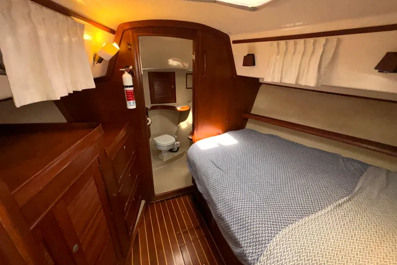 Slide: The Image of Cozy cabin interior of 1995 Island Packet 40 sailboat with bed and bathroom. - 21