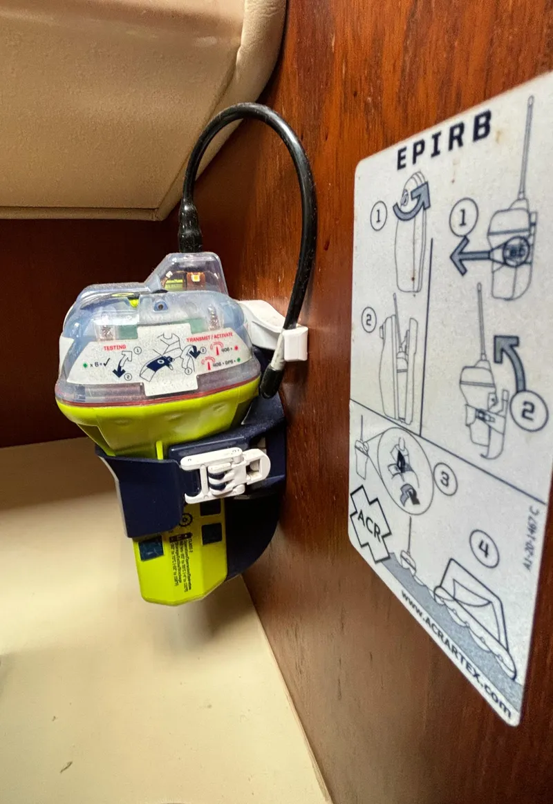 Slide: The Image of EPIRB device on 1995 Island Packet 40 sailboat with usage instructions. - 24